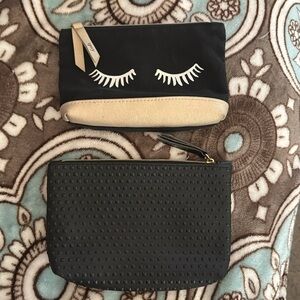 2 small cosmetic bags from Ipsy; black textured and eyelashes with gold details